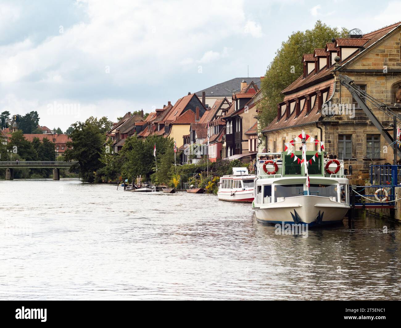 Bamberg Regnitz river with old buildings of Klein Venedig and full tourist boats. Vacation activity when traveling in Germany during summer. Stock Photo