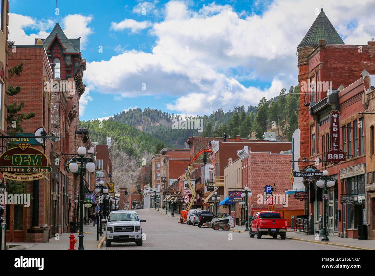 Deadwood, South Dakota, USA - March 2017. The quiet main street of Deadwood set against a mountain backdrop. Stock Photo