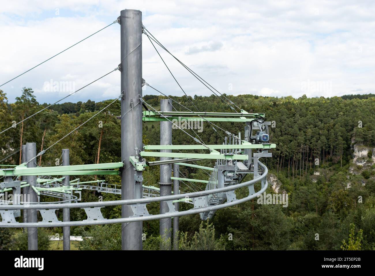 Rail track of a fun park ride in the nature. The steel building is solid and capable of holding a gondola. The attraction is popular with tourists. Stock Photo