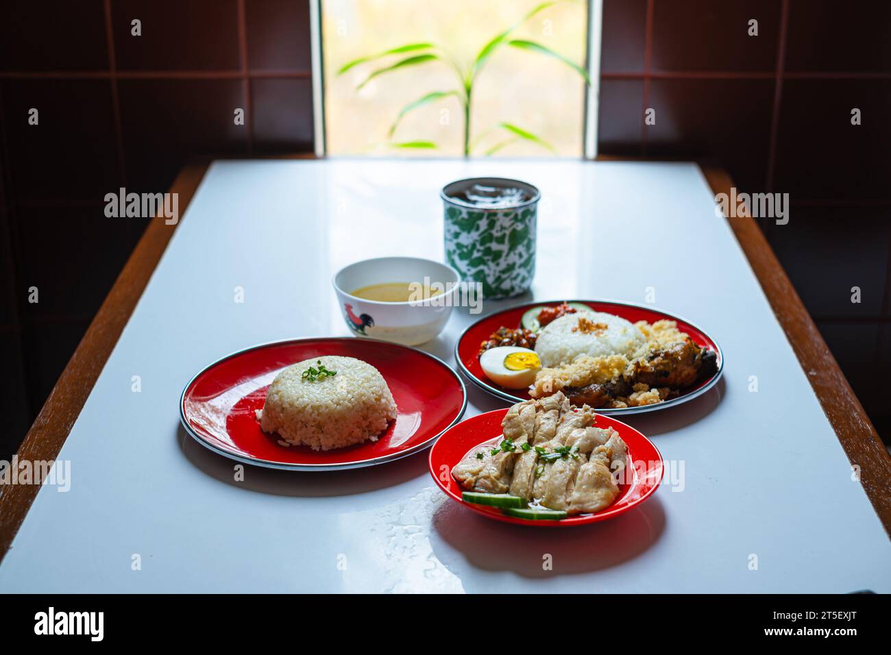 A menu set of Malaysian typical dish or food. Nasi Hainan, Nasi Lemak, and a cup of coffee. Stock Photo