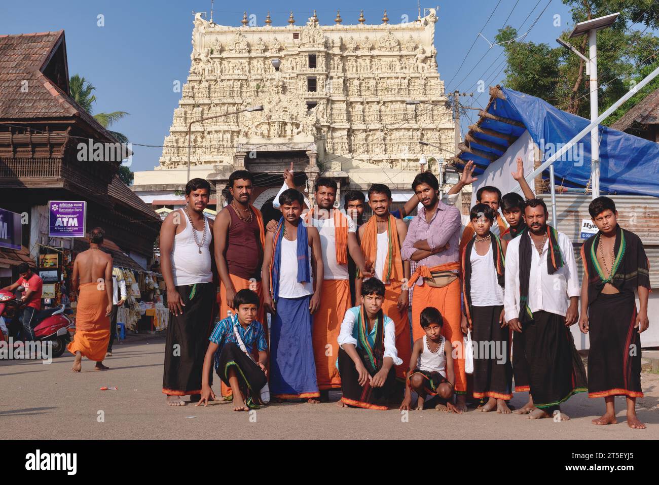 A group of exclusively male Hindu pilgrims posing for photos in front of Padmanabhaswamy Temple in Trivandrum (Thirivanathapuram), Kerala, India Stock Photo