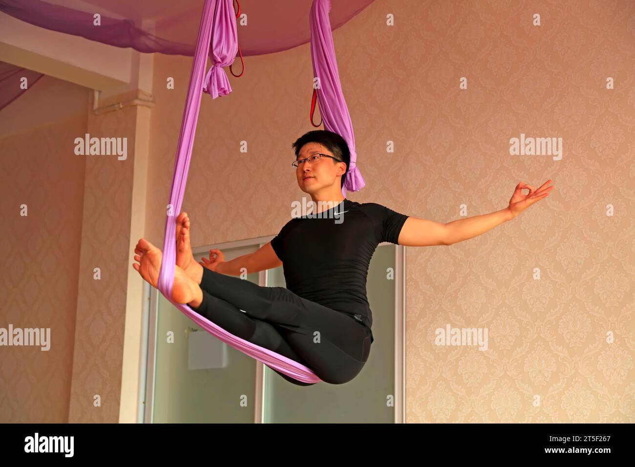 Luannan County - October 3, 2016: air yoga instructors doing demonstrative movements in a yoga training field, Luannan, Hebei, China Stock Photo