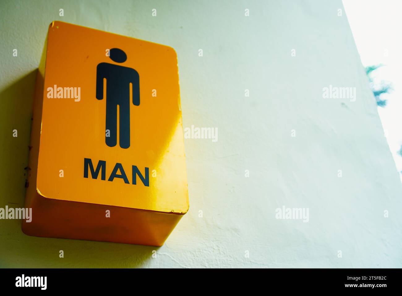 The male gender sign in close-up, adorning a clean white wall with minimalist elegance Stock Photo