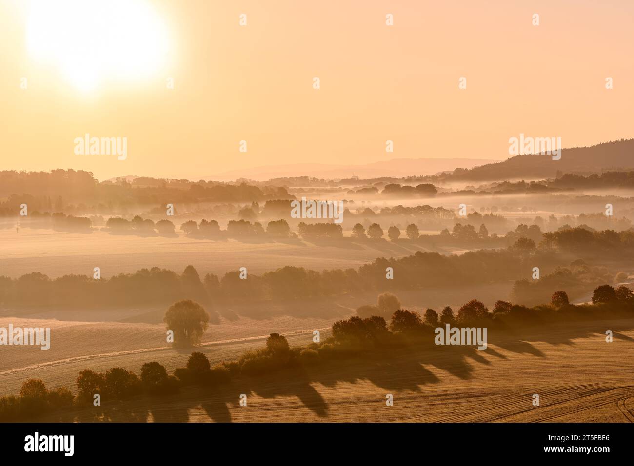 Sleepy morning in Bohemian Paradise. Aerial view of misty morning landscape with rising sun. Stock Photo