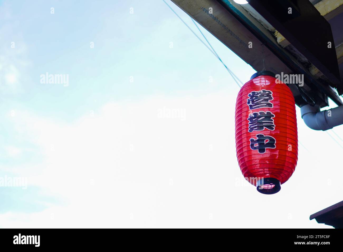 Chinese red lanterns hang from the roof outside Stock Photo - Alamy