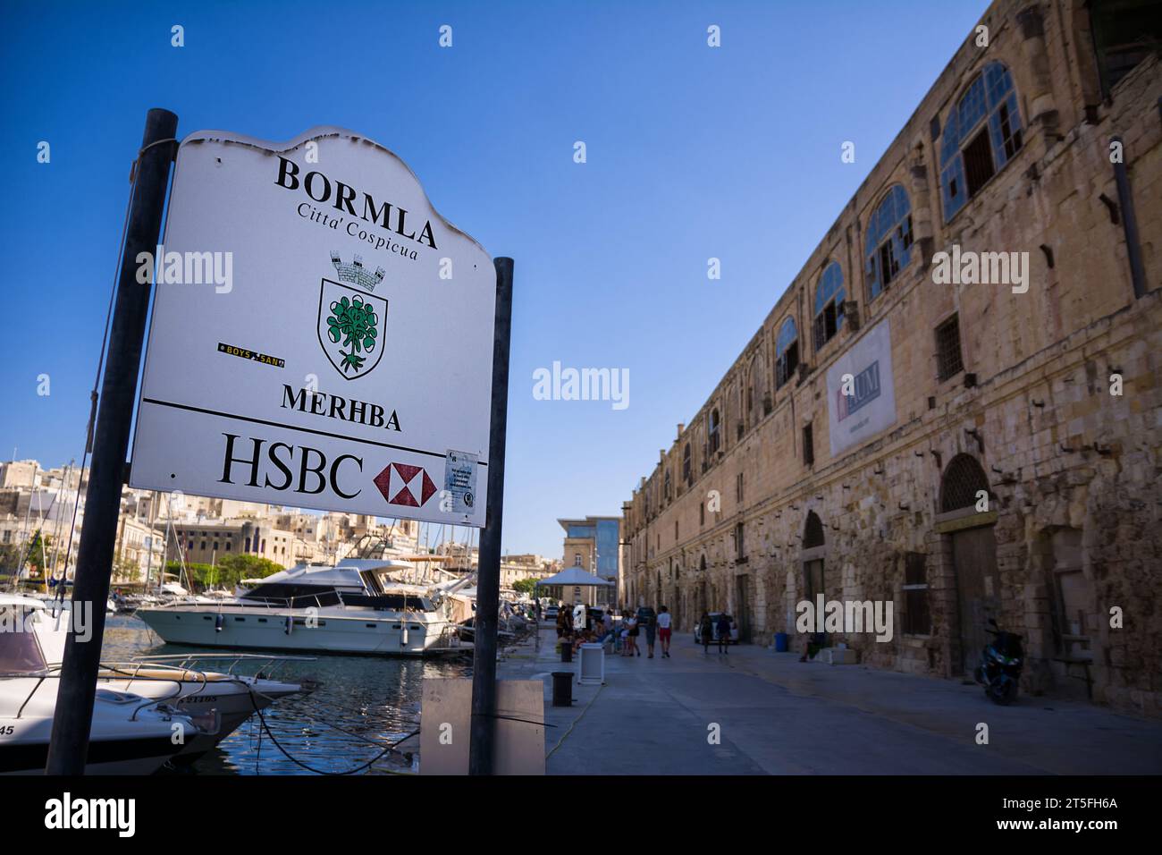Cospicua, Malta - 17 June 2023: Cospicua port pier with road sign Stock Photo