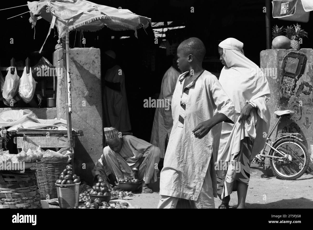 a day at market in Kano state Nigeria, showing how people are passing by, unable to buy enough food due to the rise in prices. Stock Photo