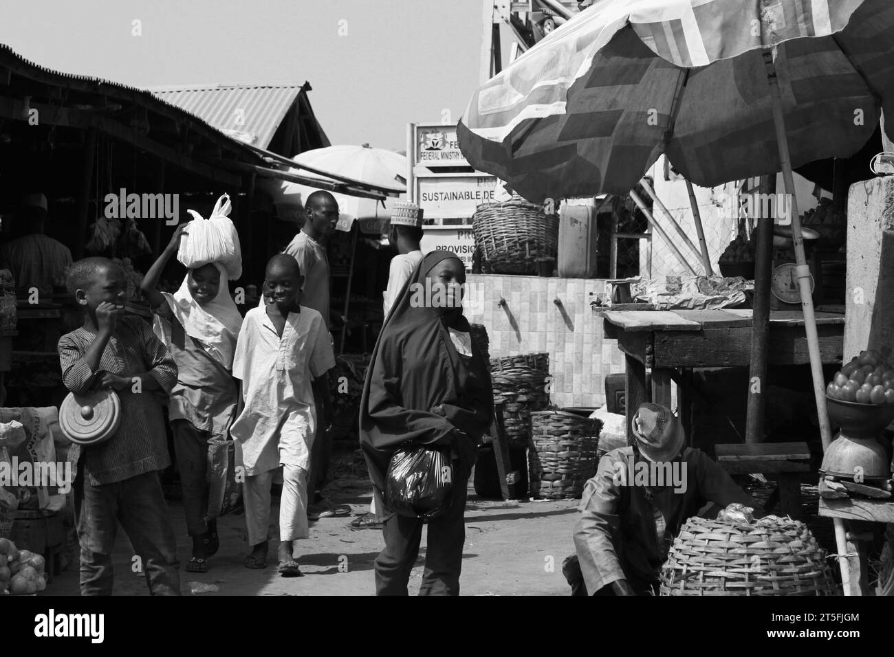 a day at market in Kano state Nigeria, showing how people are passing by, unable to buy enough food due to the rise in prices. Stock Photo