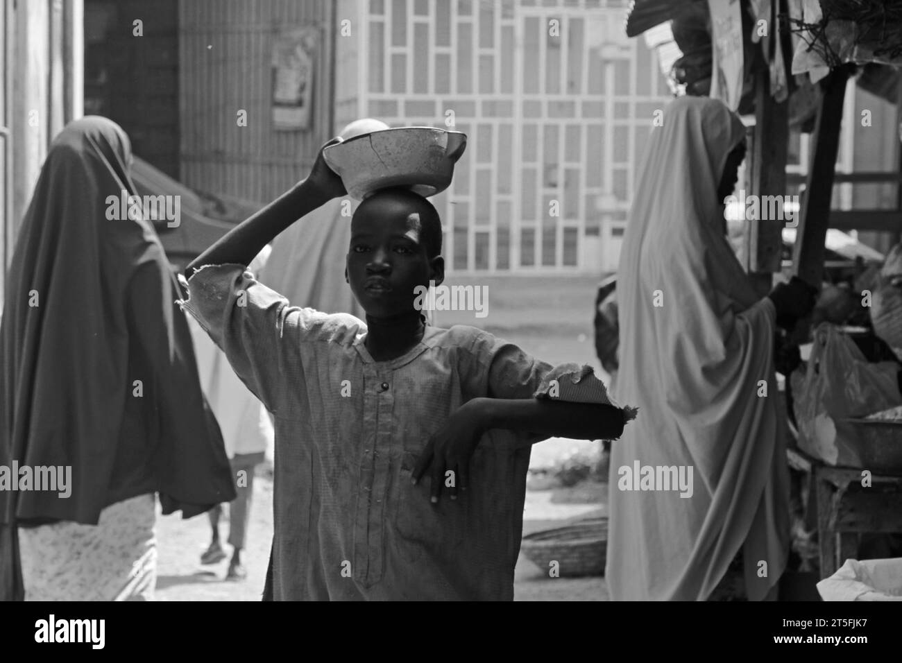 a day at market in Kano state Nigeria, showing how people are passing by, unable to buy enough food due to the rise in prices. Stock Photo