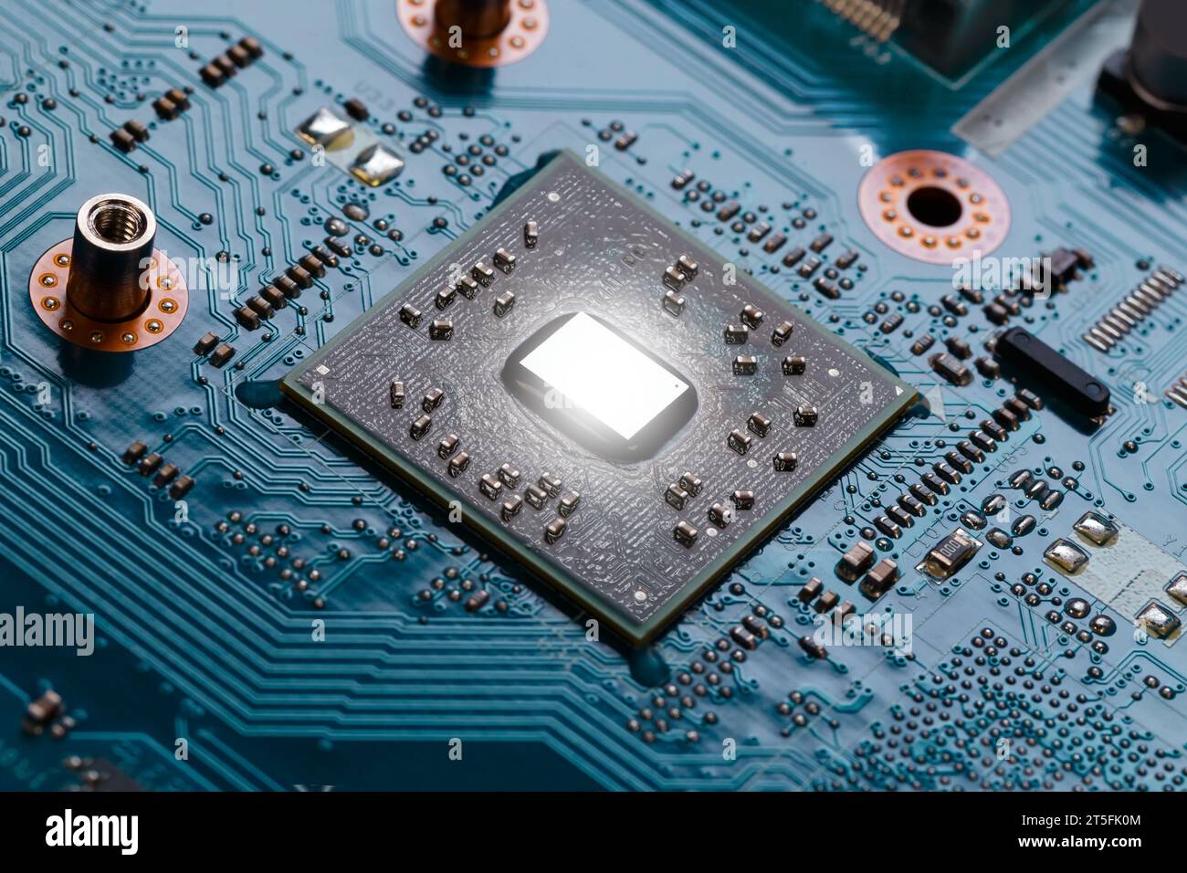 A mobile CPU with a removed cooling radiator on a laptop motherboard. Macro photography Stock Photo
