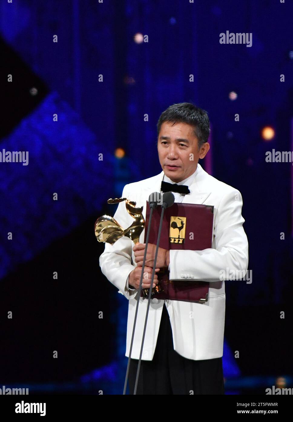 Xiamen, China's Fujian Province. 4th Nov, 2023. Tony Leung Chiu-Wai wins the best actor award for his performance in 'Hidden Blade' during the awarding ceremony of the 36th Golden Rooster Awards in Xiamen, southeast China's Fujian Province, Nov. 4, 2023. Winners of the 36th Golden Rooster Awards were announced Saturday evening in Xiamen. Credit: Wei Peiquan/Xinhua/Alamy Live News Stock Photo