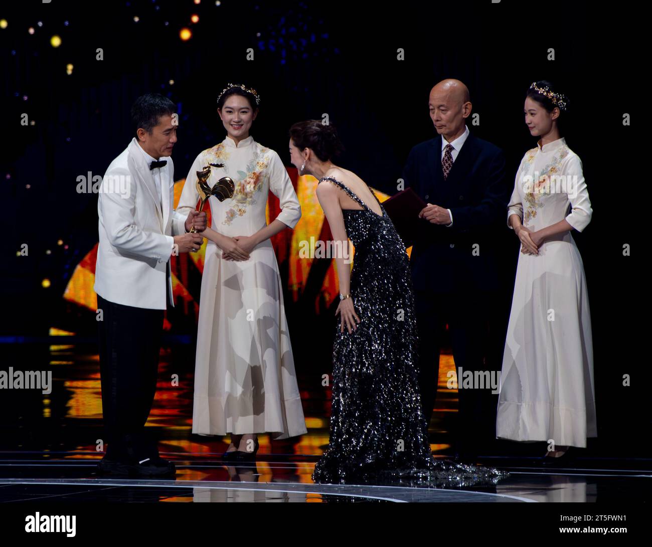 Xiamen, China's Fujian Province. 4th Nov, 2023. Tony Leung Chiu-Wai (1st L) wins the best actor award for his performance in 'Hidden Blade' during the awarding ceremony of the 36th Golden Rooster Awards in Xiamen, southeast China's Fujian Province, Nov. 4, 2023. Winners of the 36th Golden Rooster Awards were announced Saturday evening in Xiamen. Credit: Wei Peiquan/Xinhua/Alamy Live News Stock Photo
