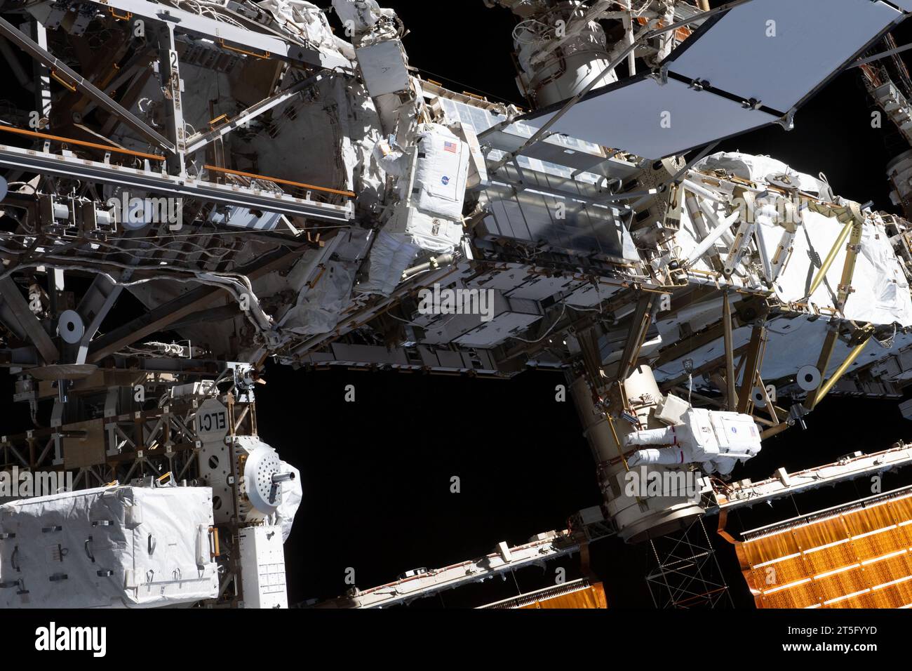International Space Station, Earth Orbit. 01 November, 2023. NASA astronauts and Expedition 70 Flight Engineers Jasmin Moghbeli, bottom right, and Loral O'Hara, center, perform a spacewalk to replace one of the 12 trundle bearing assemblies on the port solar alpha rotary joint, outside the International Space Station, November 1, 2023 in Earth Orbit. The assembly allows the solar arrays to track the Sun and generate electricity to power the orbiting laboratory. Credit: NASA Astronaut/NASA/Alamy Live News Stock Photo