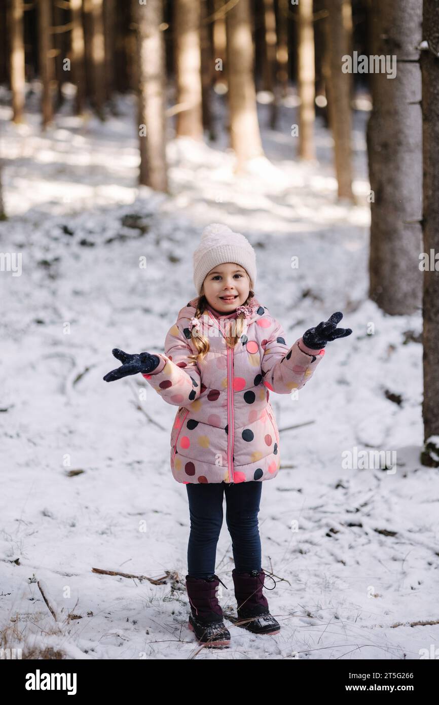 Adorable little girl in big snowy forest. Happy childhood Stock Photo ...