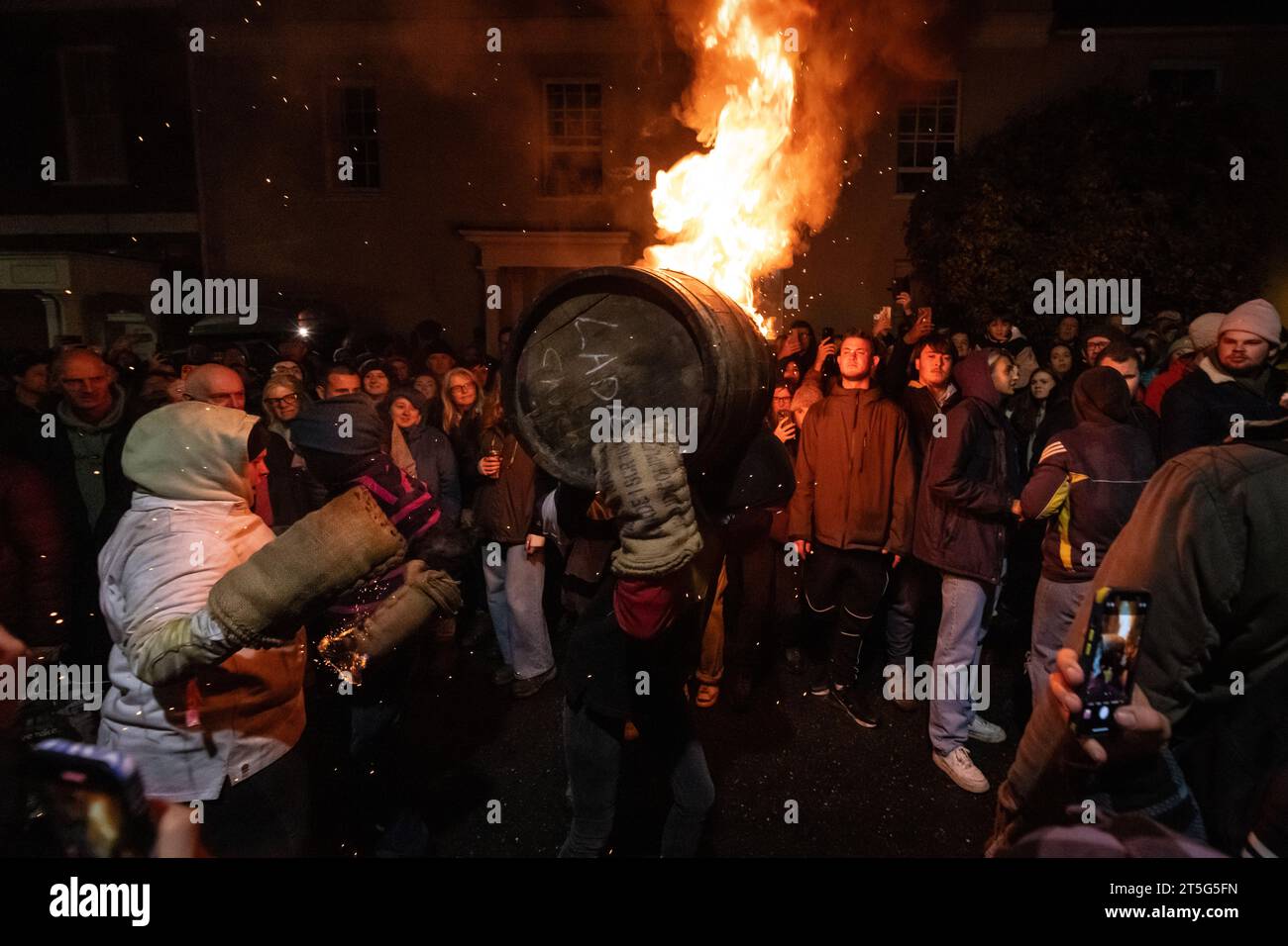 Ottery St Mary, UK. Saturday 4 November 2023. Locals take part in the Ottery St Mary Burning Tar Barrels. Running with burning barrels through the streets of Ottery St Mary in Devon in a traditional event stretching back hundreds of years. Credit: Thomas Faull/Alamy Live News Stock Photo