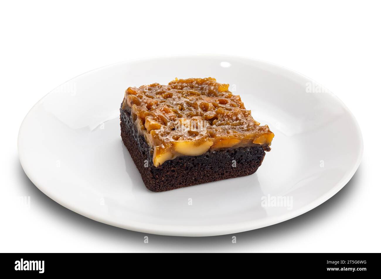 Toffee cake topping with cashew nut and caramel in white ceramic dish