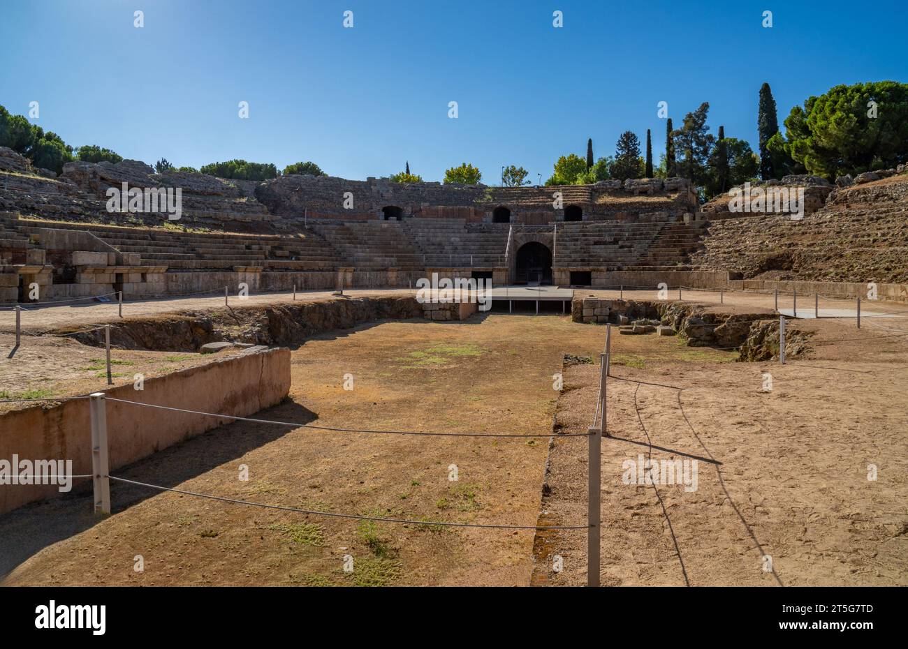 View from the arena of the Roman Amphitheater of Mérida illuminated by the light of dawn creating shadows on its stands in Badajoz, Extremadura, Spain Stock Photo