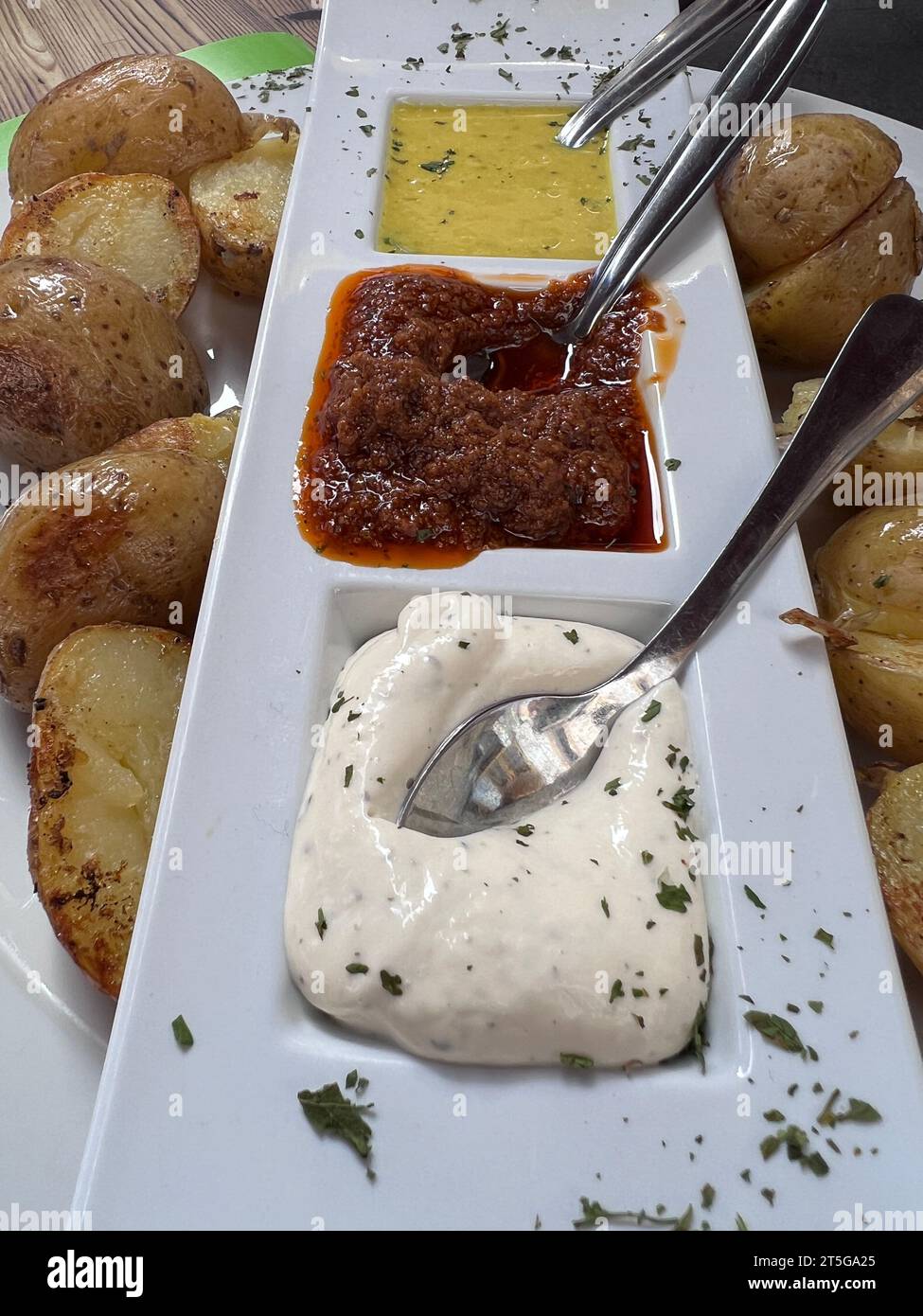 potato dish with three sauces Stock Photo