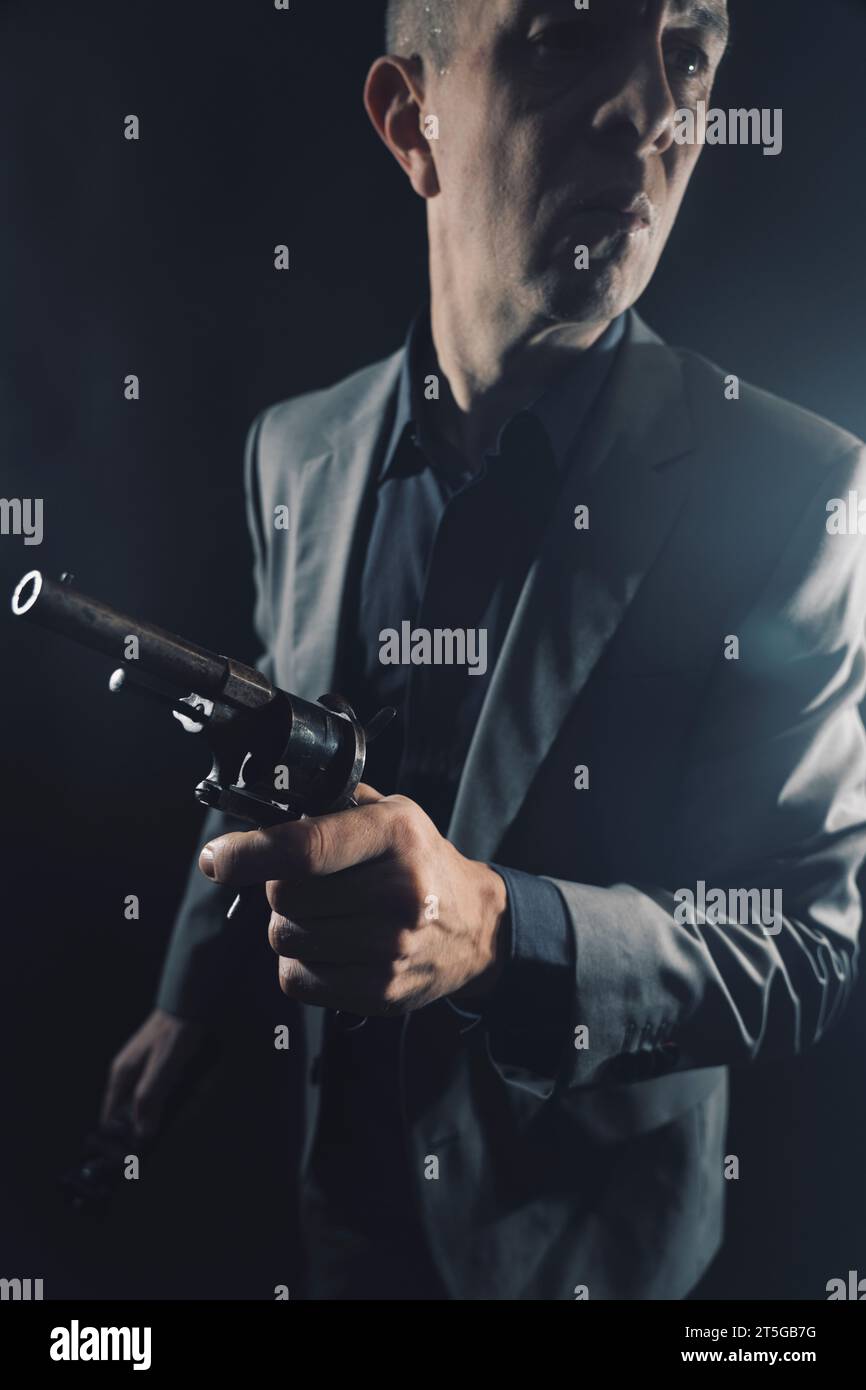 Spy in elegant suit with pistol gun in dark studio shot photo with ...