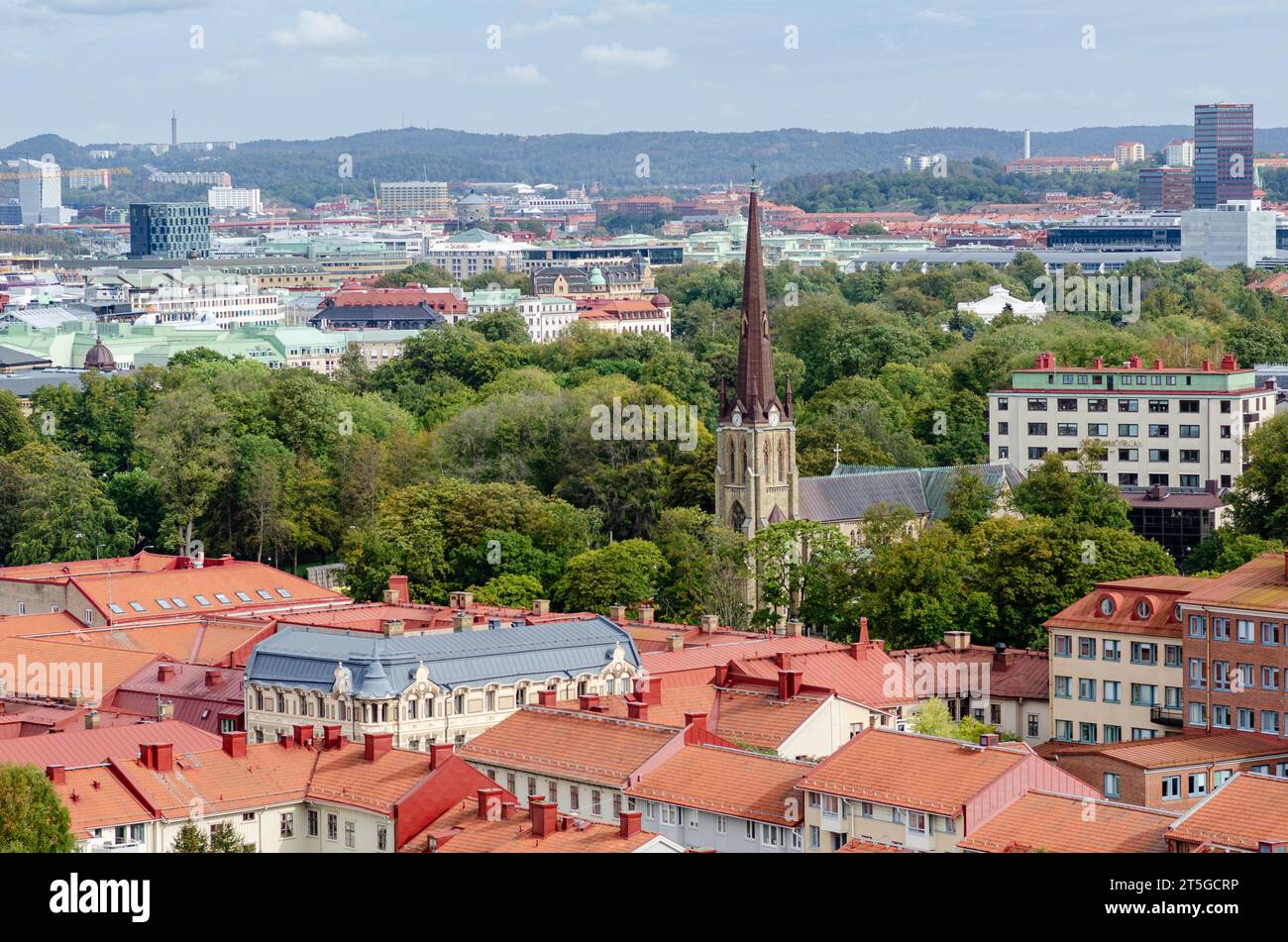 Aerial view of the Haga church (Hagakyrkan) in Gothenburg, Sweden surrounded by red rooftops and green trees Stock Photo