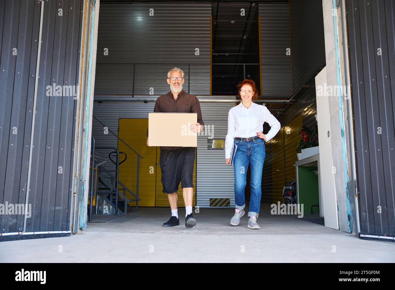Man woman walk through warehouse hi-res stock photography and images ...
