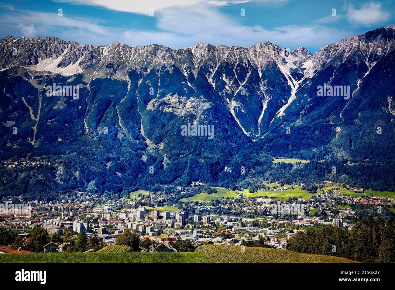 The Austrian Alps rise steeply behind the city of Innsbruck, Austria ...