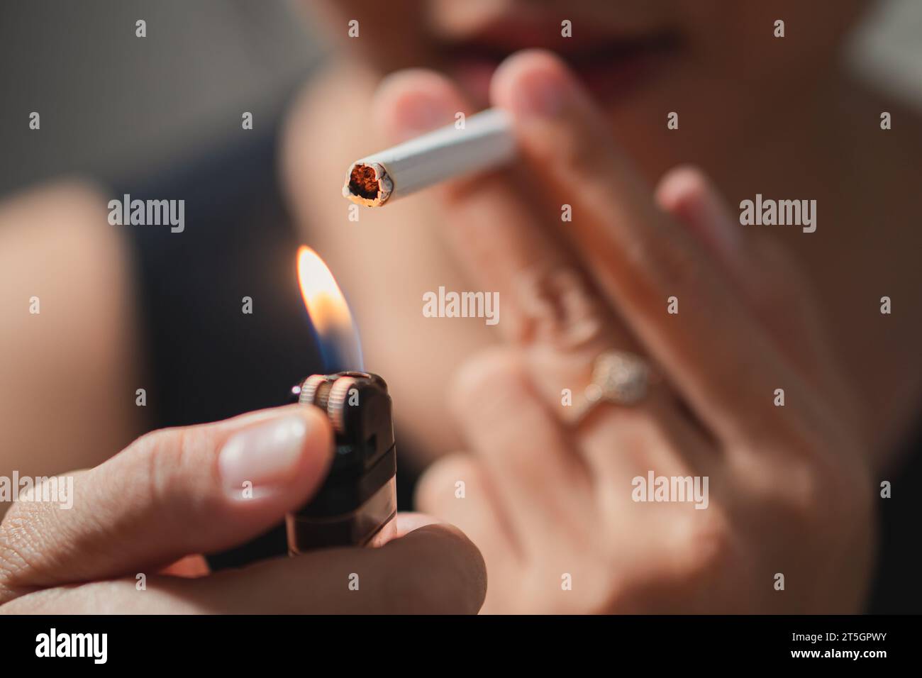 Smoker lighting a cigarette with lighter Stock Photo Alamy