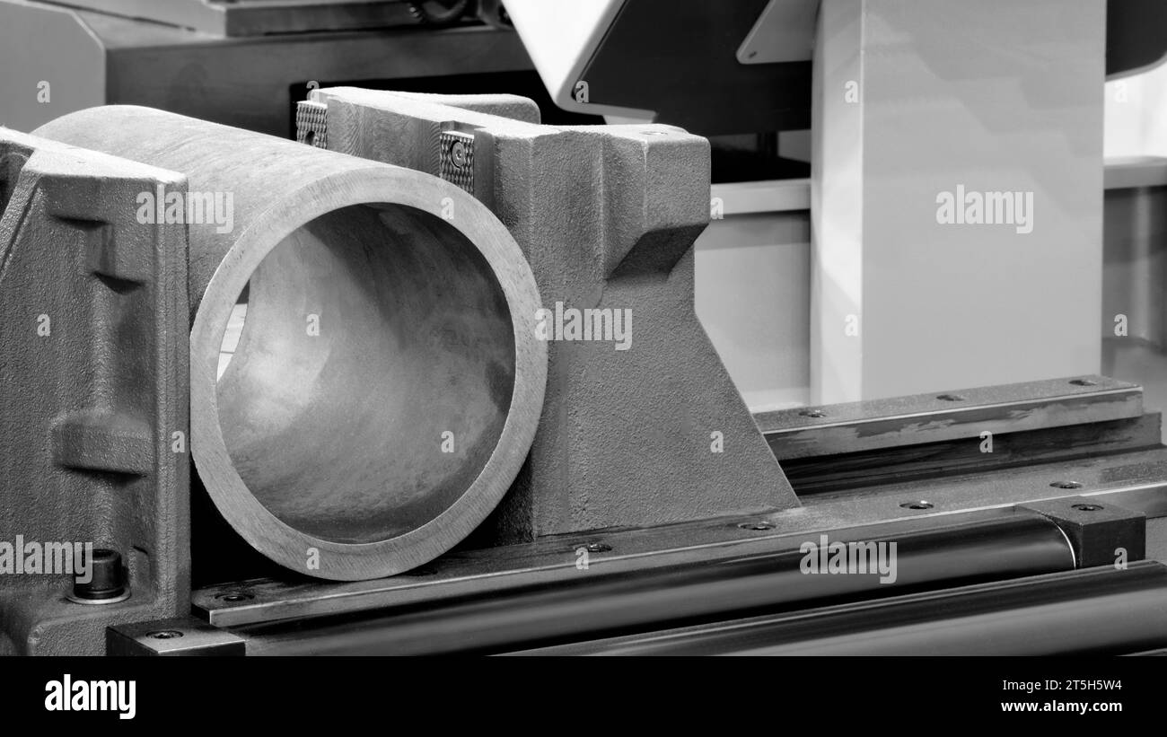 The automatic band saw machine cutting the metal bar with coolant