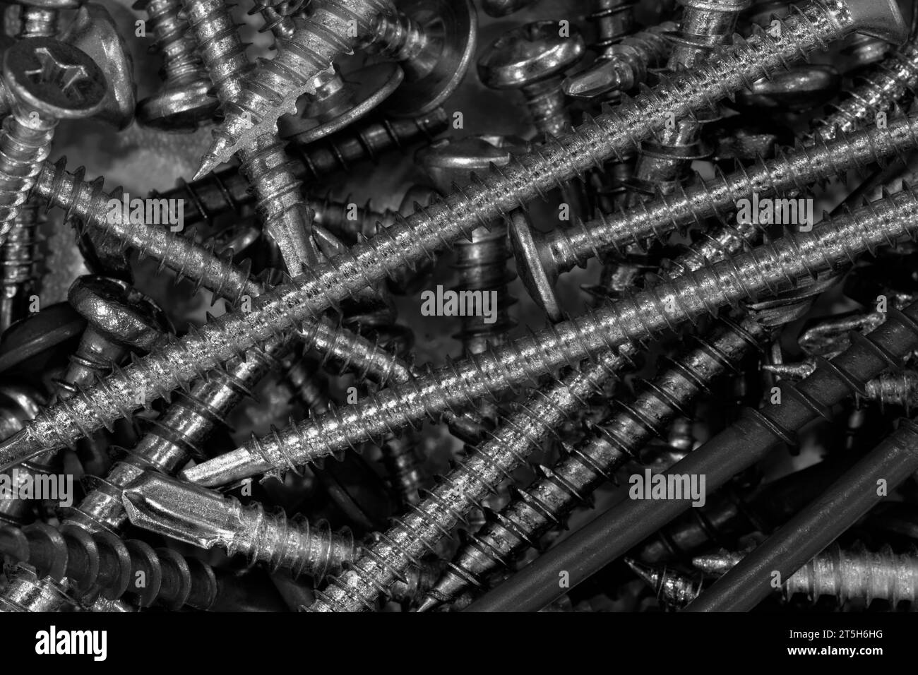 A lot of screws flat lay abstract background in blue tone Stock Photo