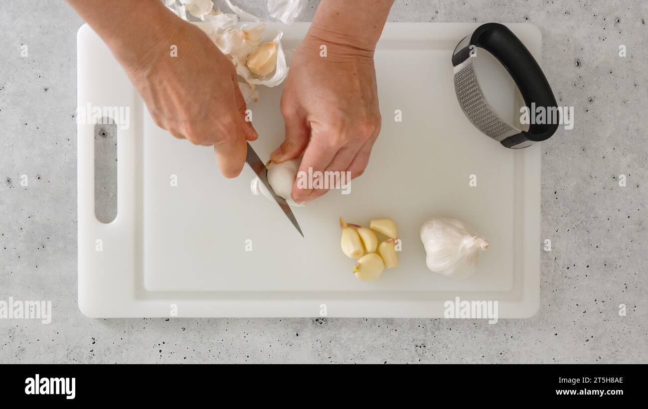 Woman peeling garlic hands knife hi-res stock photography and images ...