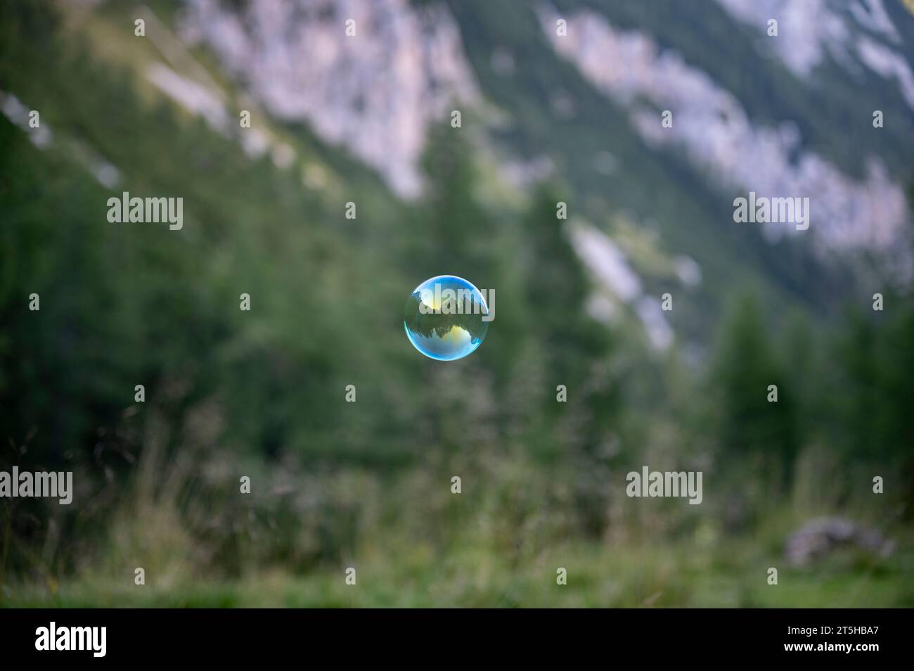One single transparent soap bubble floating through the air in the ...