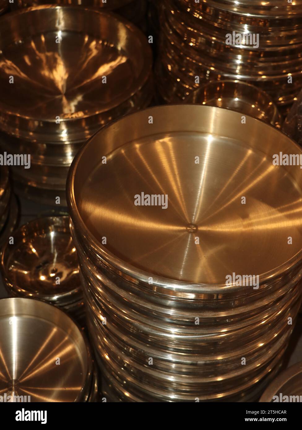 vintage copper plates for the kitchen stacked in rows in the market