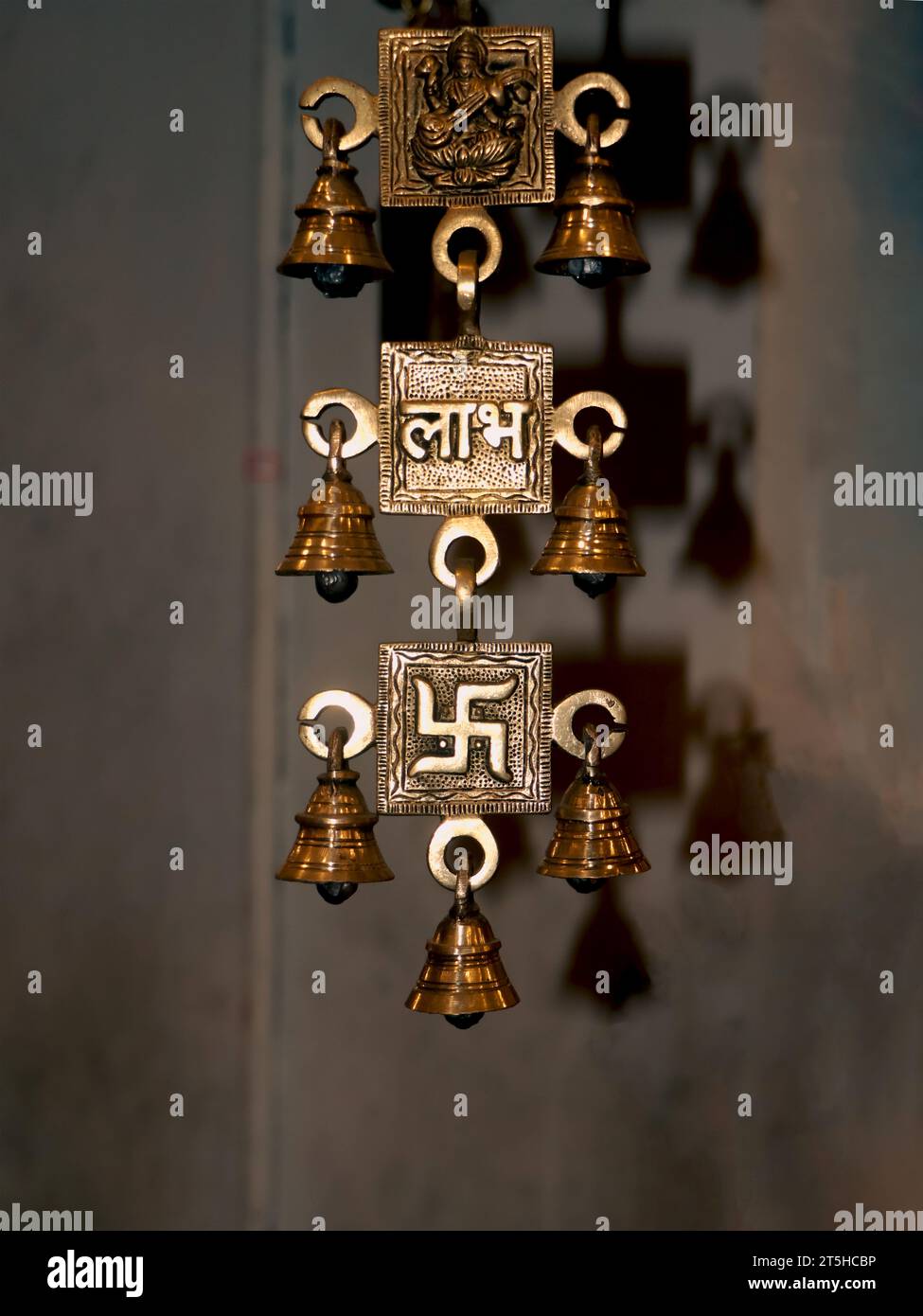 old,souvenir hanging brass bells with religious symbols from an antique