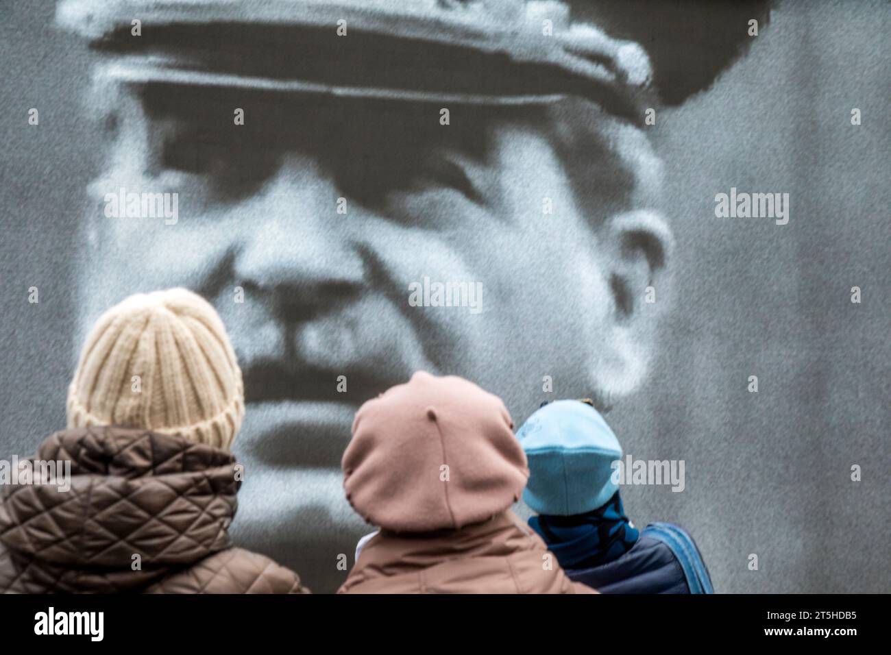 Moscow, Russia. 5th of November, 2023. Visitors in an open-air museum in Red Square in Moscow watch the historical chronicle on the big screen; the museum opened to mark the 82th anniversary of the historical 7 November 1941 Red Square Parade when Red Army troops were leaving for the front lines of World War II to defend Moscow from the Nazi forces. Stock Photo