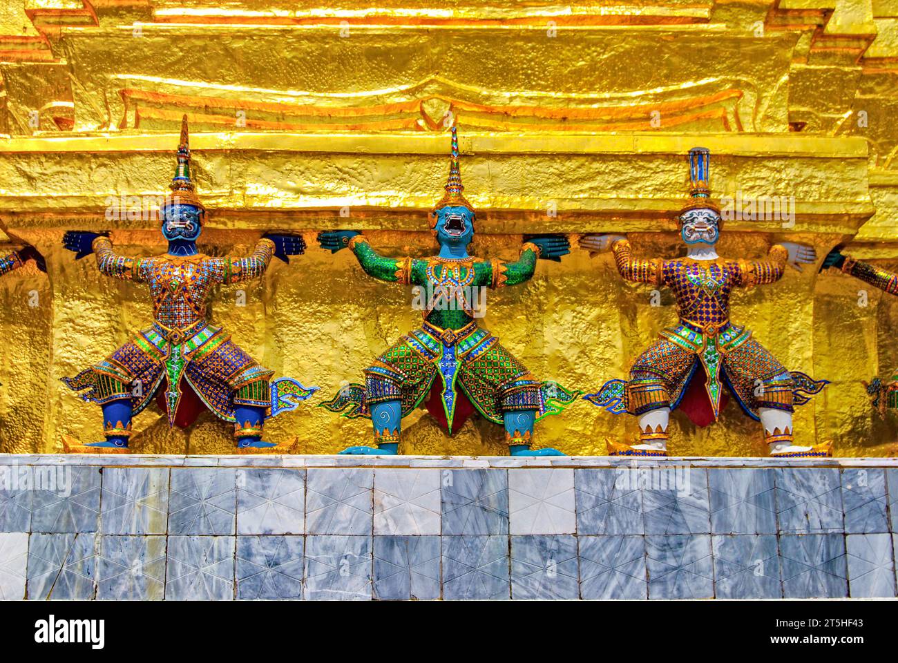 Three demons of Yaksha guard the Temple of the Emerald Buddha in Bangkok. Thailand Stock Photo