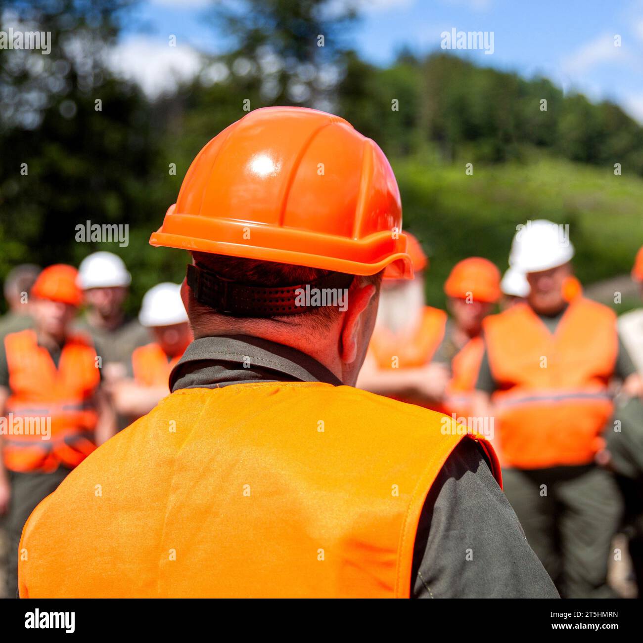 Building concept. Architector, engineers on constructing site. Helmet builder. Many construction workers helmet. Engineer team in hardhat for work Stock Photo
