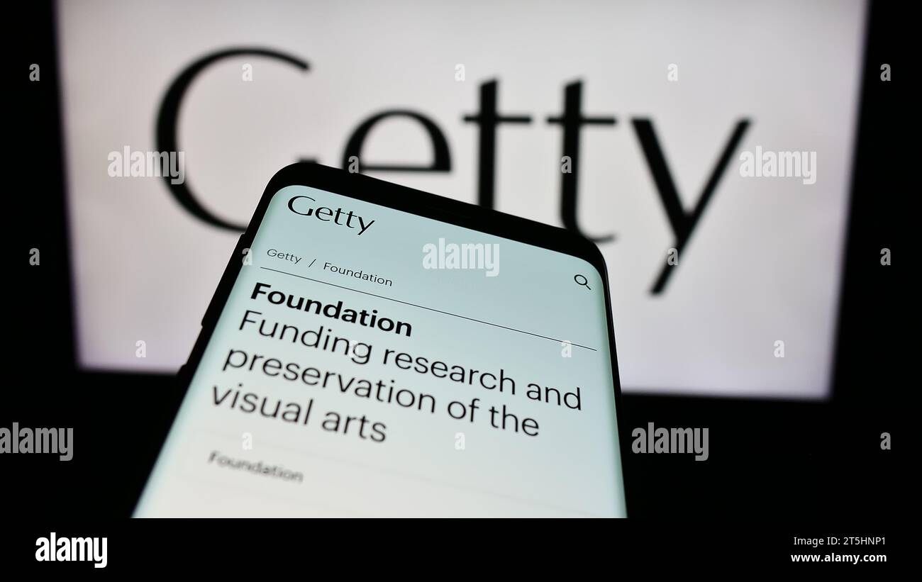Smartphone with website of US art foundation J. Paul Getty Trust in front of logo. Focus on top-left of phone display. Stock Photo