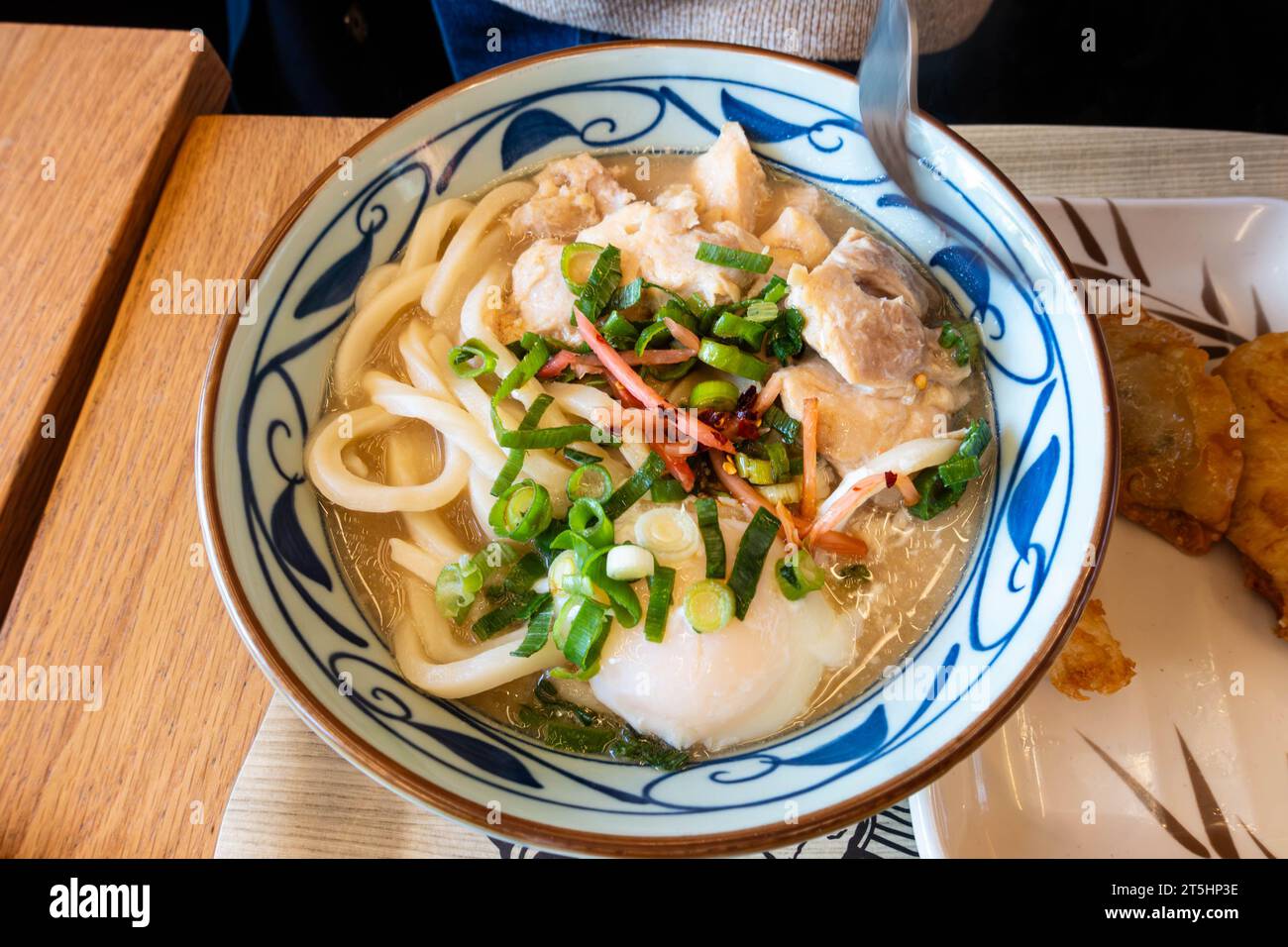 Chicken paitan, a Japanese dish with udon noodles and chicken served in a broth. Stock Photo