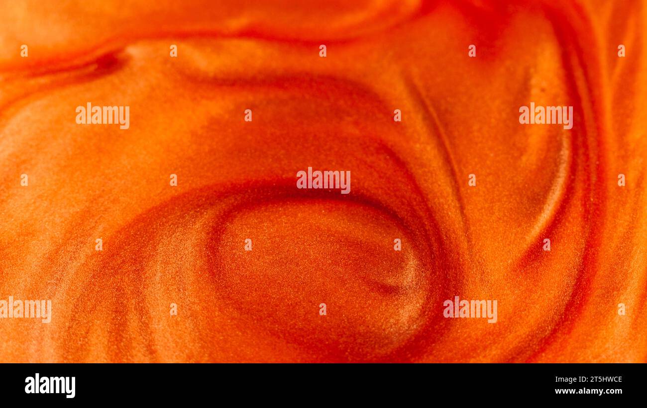 Ink background glitter paint orange liquid flow Stock Photo - Alamy