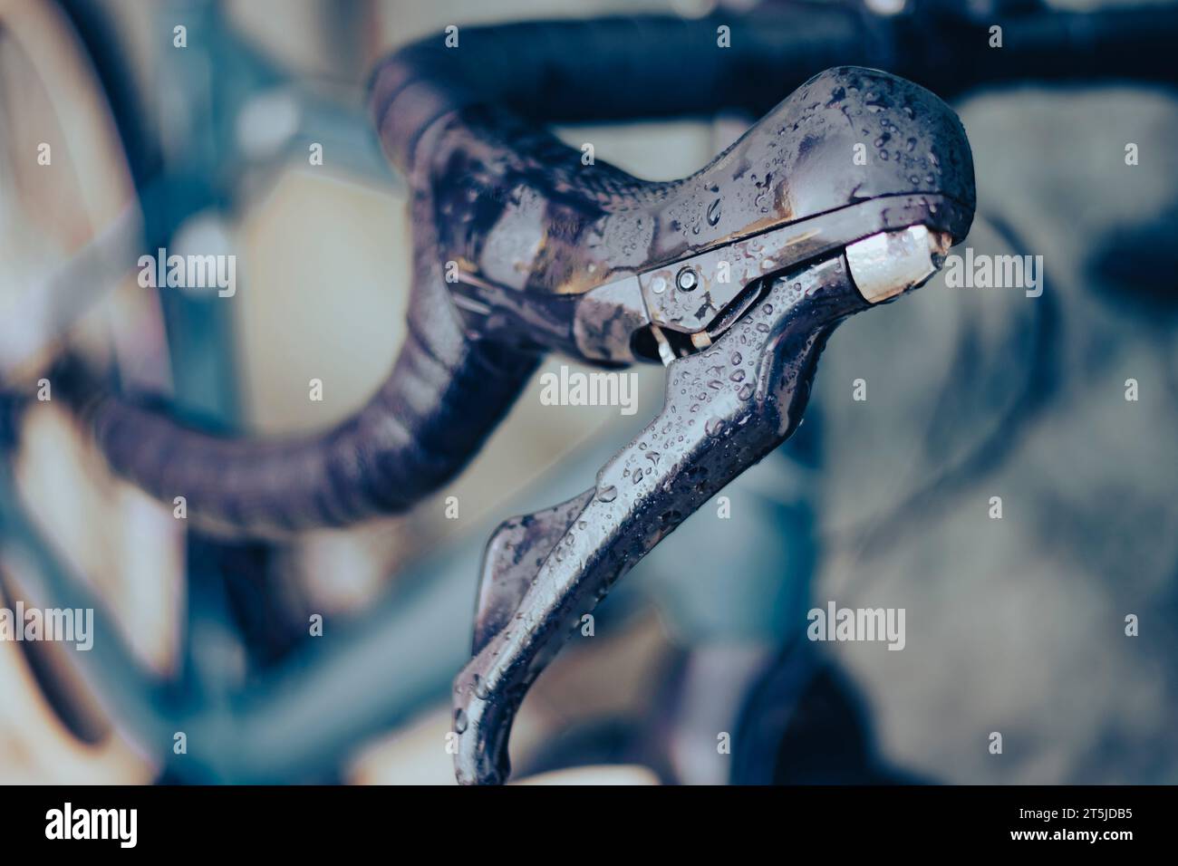 Right brake lever on a gravel bike covered with rain drops on a drop