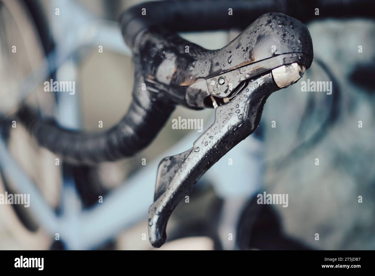 Right brake lever on a gravel bike covered with rain drops on a drop