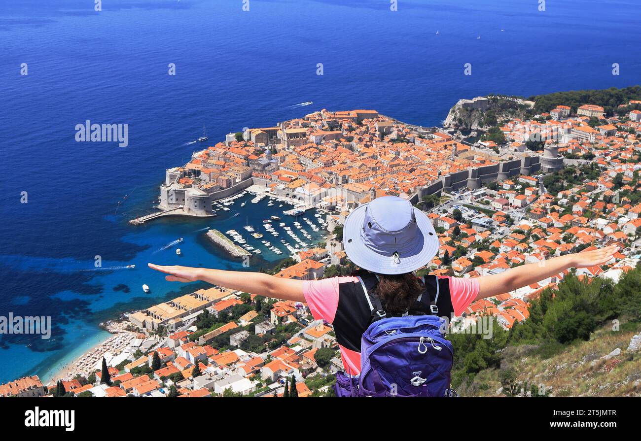 Teenager girl hiker enjoying Dubrovnik Old Town view on Adriatic Sea coast, Croatia, Europe Stock Photo
