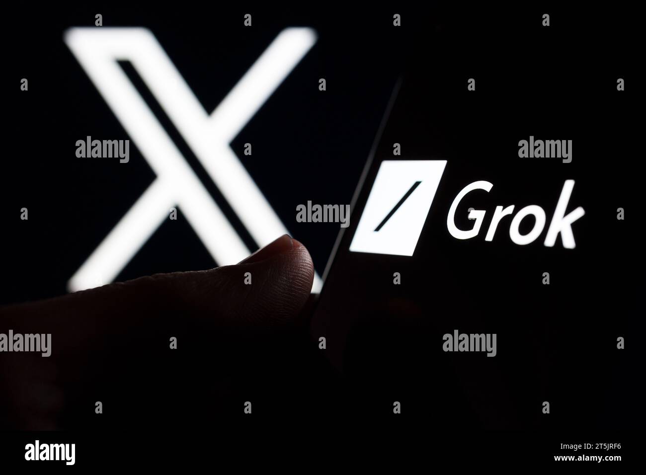 Grok AI chatbot logo seen on smartphone screen and finger pointing at it. Grok is a new chat bot for X platform. Stafford, United Kingdom, November 5, Stock Photo