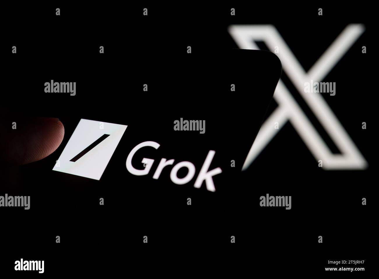 Grok AI chatbot logo seen on smartphone screen and finger pointing at it. Grok is a new chat bot for X platform. Stafford, United Kingdom, November 5, Stock Photo