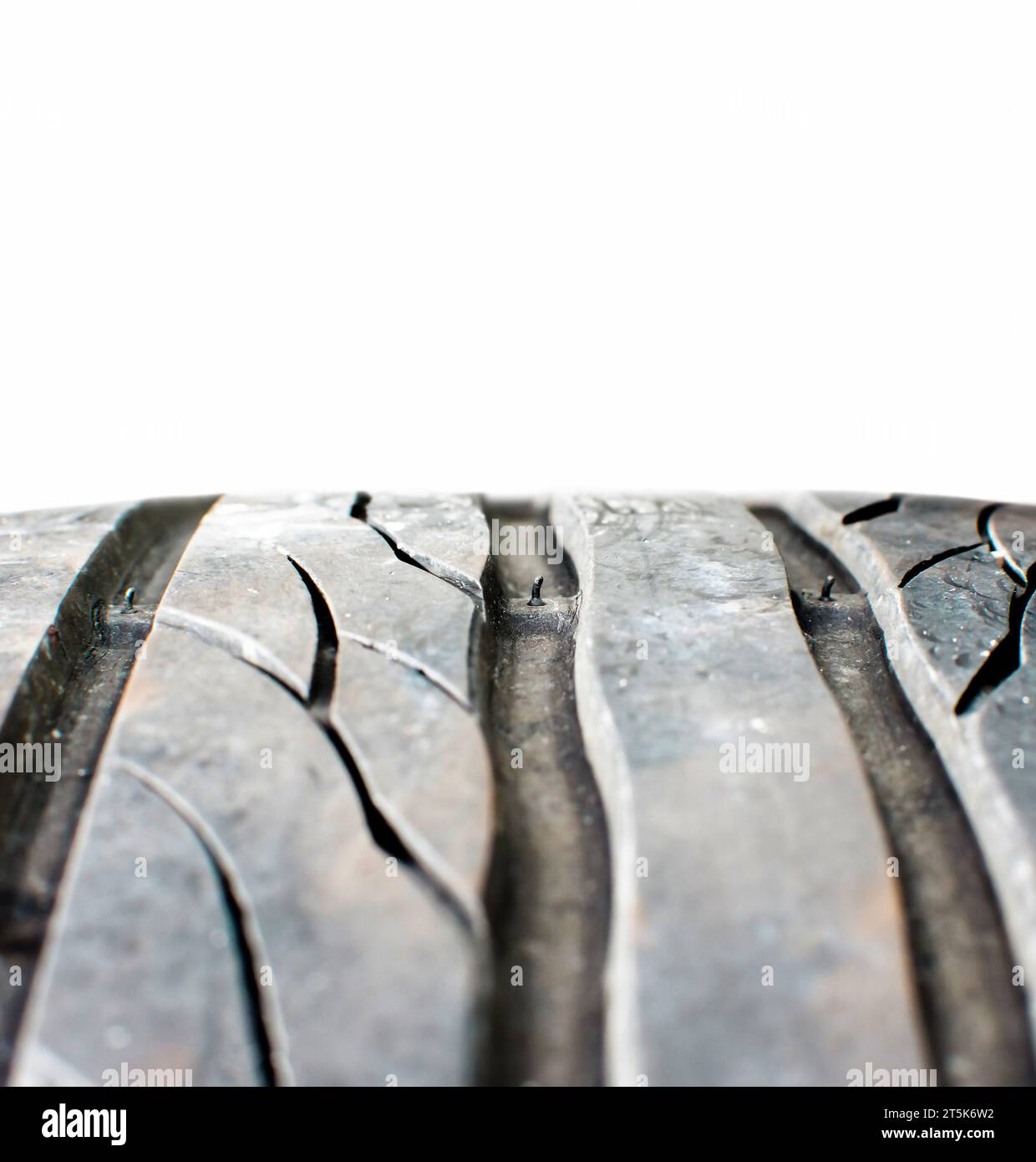 Tire tread wear indicator showing on tread grooves on white background