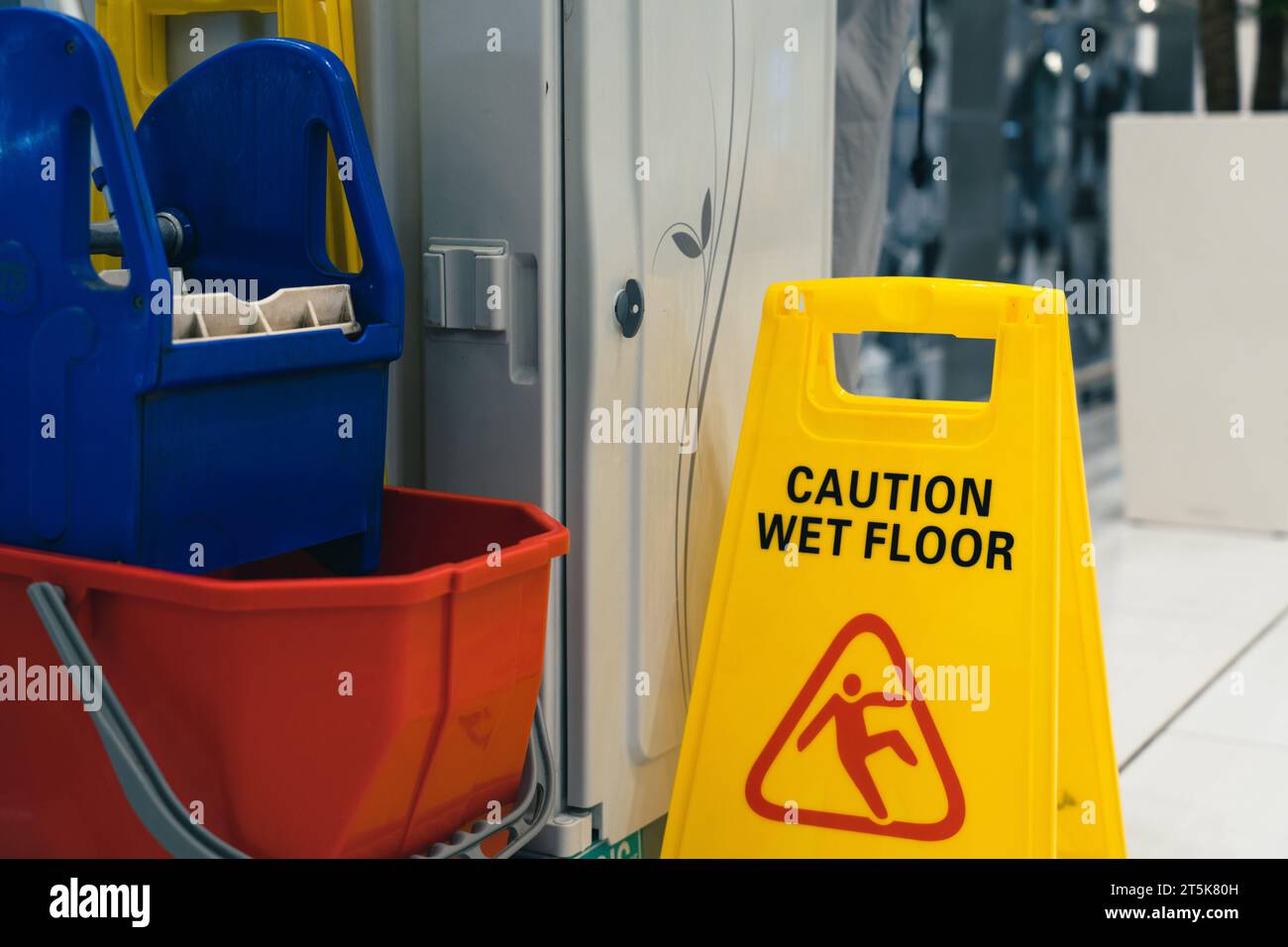 Warning sign slippery with Cleaning Cart Stock Photo - Alamy