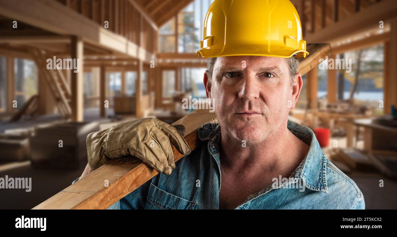 Male Contractor at a Construction Site Wearing a Hard Hat and Work