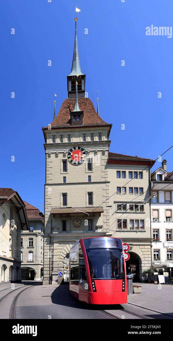 The city center of Bern with a street including a red tramway and the clock tower, Switzerland Stock Photo