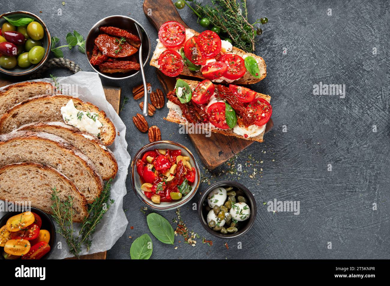 Italian antipasti snacks set. Tasty bruschettas with cheese, sun-dried tomatoes. Traditional food concept. Top view., copy space. Stock Photo