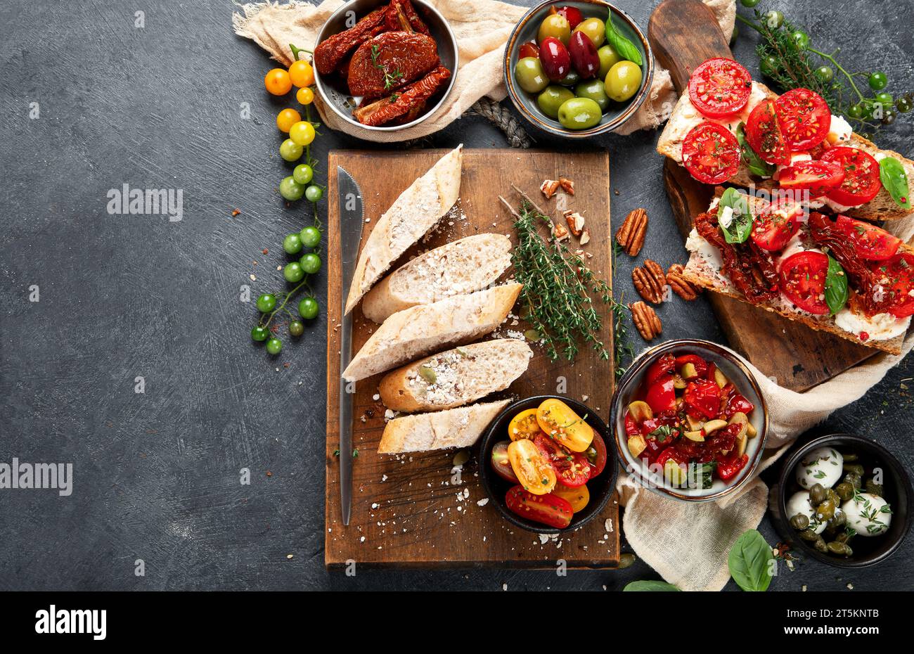 Italian antipasti snacks set. Tasty bruschettas with cheese, sun-dried tomatoes. Traditional food concept. Top view, copy space. Stock Photo
